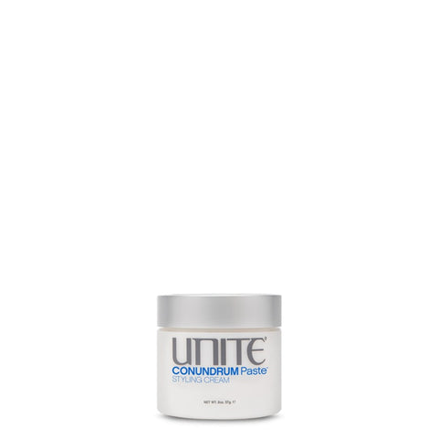 White tub of conundrum paste with silver cap. This paste is formulated to help control and add style and separation to short hair.